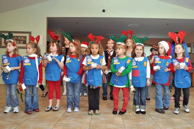 Children caroling at a senior living community